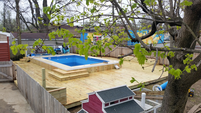 Above Ground Pool Deck with built in amenities such as storage benches, and flower boxes.
